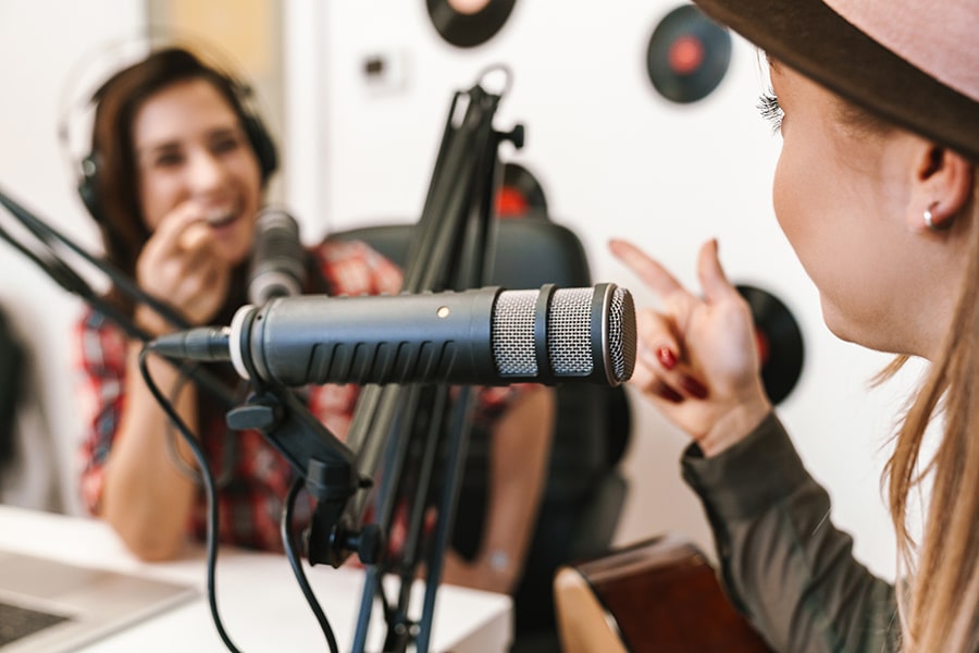Happy woman singer performing at radio program