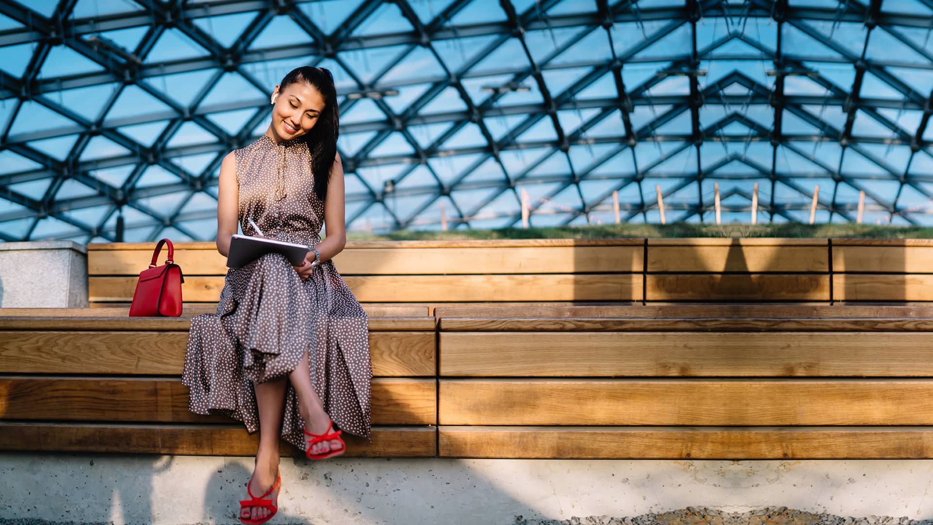Cheerful female freelancer creating graphic content during remot
